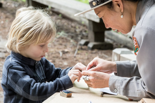 Superintendent Lehnertz leads the N.P.S. Chinese New Years parade group complete with a Find Your Park banner and inflatable monkeys.