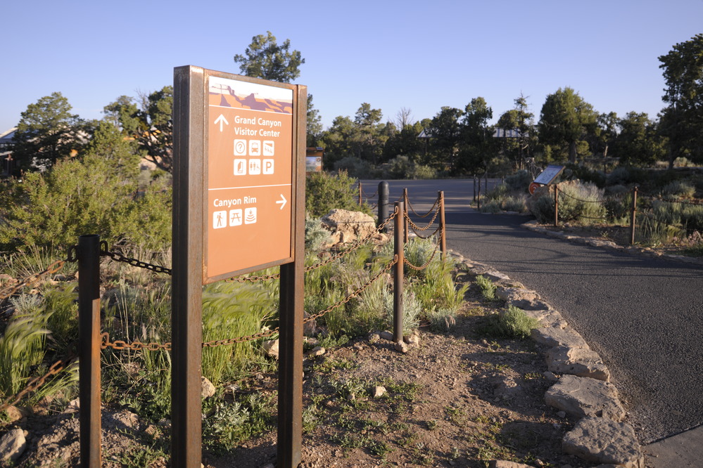 Brown sign in front of a chain 