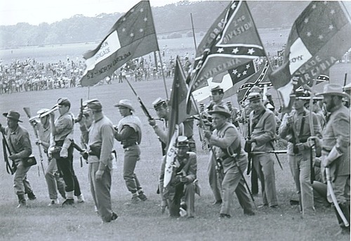 Reenactors bearing flags of fifty Confederate units and states march to the Angle, July 3, 1963.