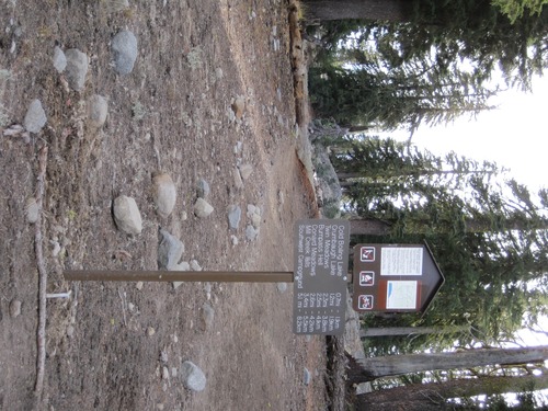 Look for the trailhead marker to the right of the restrooms at the end of the parking lot.
