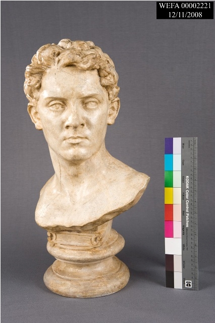 A plaster bust of a young man's head.
