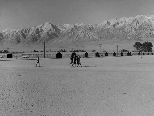 This War Relocation Authority center which houses 10,000 evacuees of Japanese ancestry is located in Owens Valley between the High Sierras and Mt. Whitney, the highest peak in the United States. The space in the foreground is a wide fire-break between blocks of barracks which also serves as a playfield.