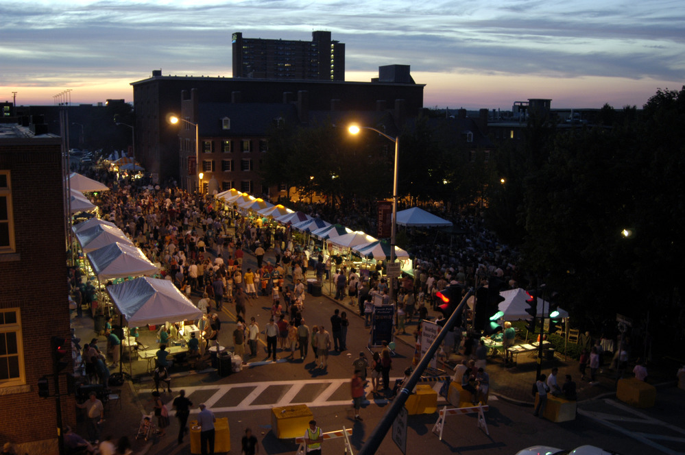 An aerial shot of a street full of people looking at various food tents during the Lowell Folk Festival