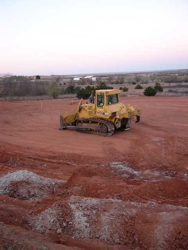 A bull dozer clears and patrols the Site in preparation of the new Cultural Heritage Center at Washita Battlefield National Historic Site.