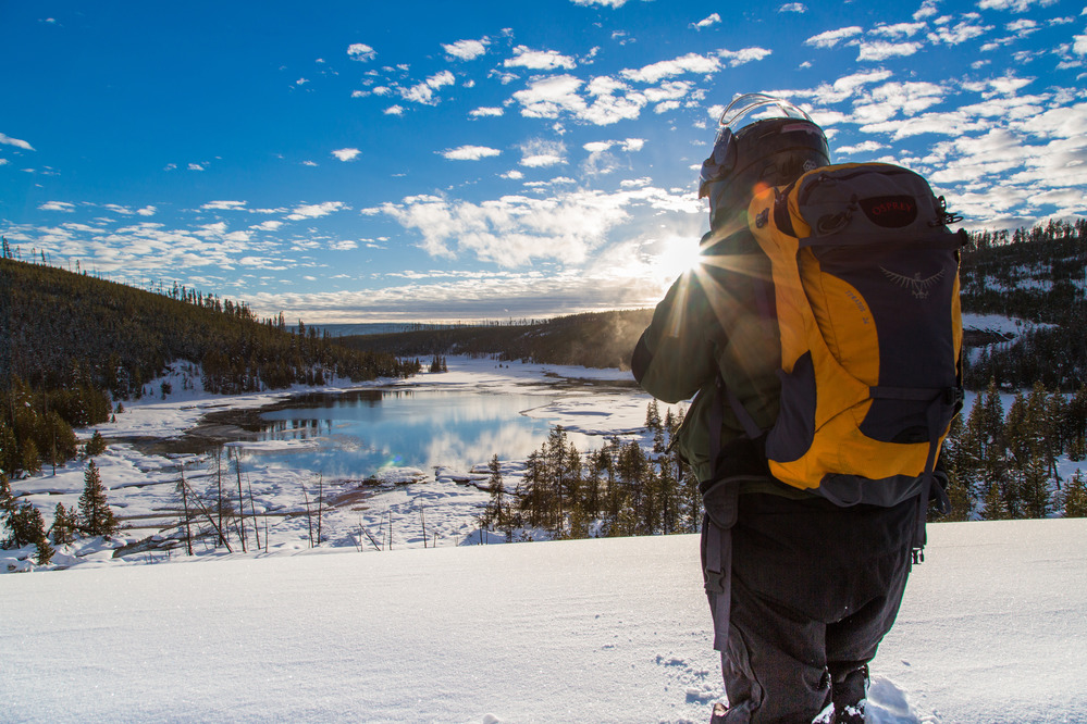 Snowmobiler photographing Nymph Lake