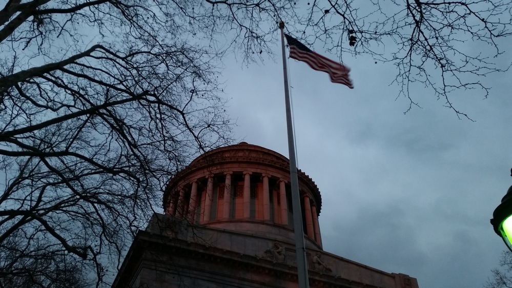 The dome of the memorial looks red in the fading light.