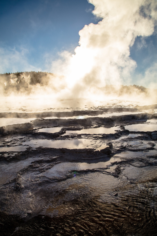 The steam and water in terraces reflect late afternoon light.