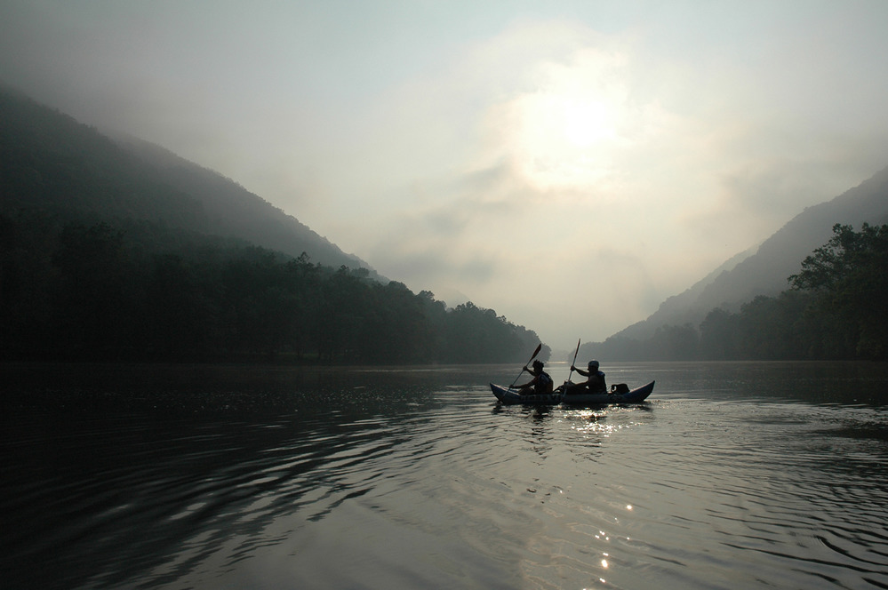 two people in a boat on calm water