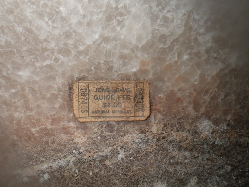 An old Jewel Cave tour ticket rests on spar crystals