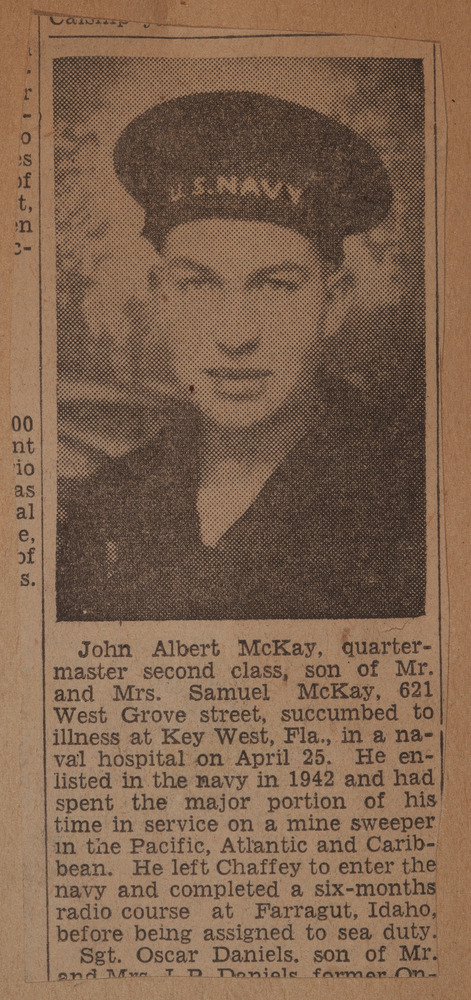 Newspaper clipping with photo of uniformed man with hat reading "U.S. Navy"