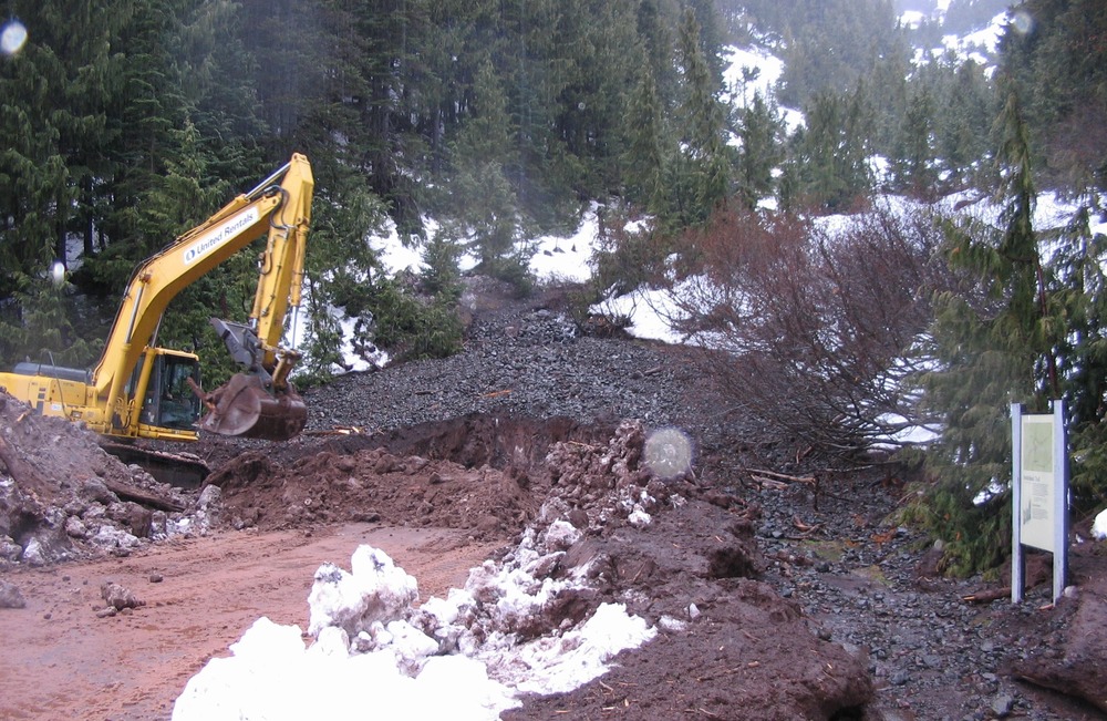 Park maintenance crews work to clear debris from parking area for popular Switchback Trail.