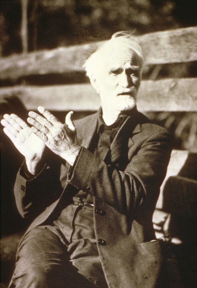 Historic photo of an elderly man clapping
