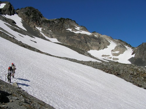 Climbers crossing snow slope in Bailey Range. Snow can be icy or soft depending on conditions.