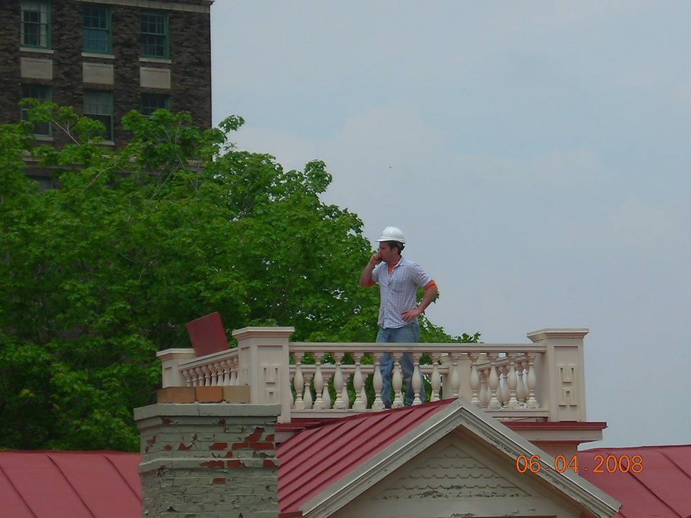 THe TR Inaugural Site Chief of Maintenance surveys his domain from the widow's walk of the Wilcox home. Inspections of the roof and chimneys were underway as part of ongoing renovations.