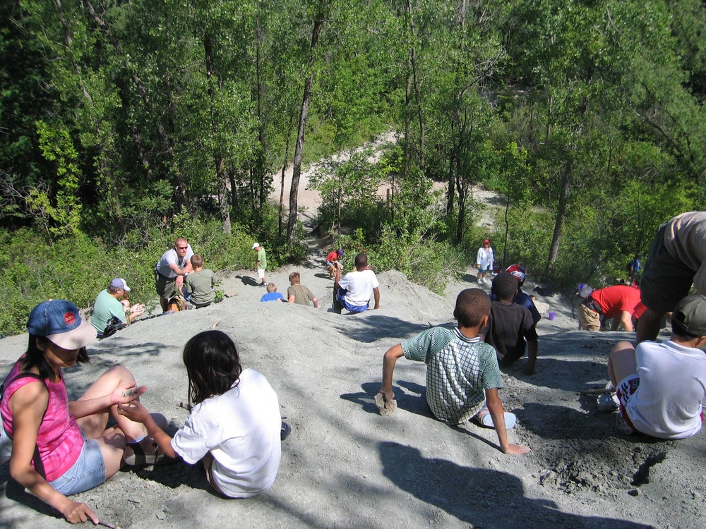 Junior Rangers search the rocky slope for fossils.