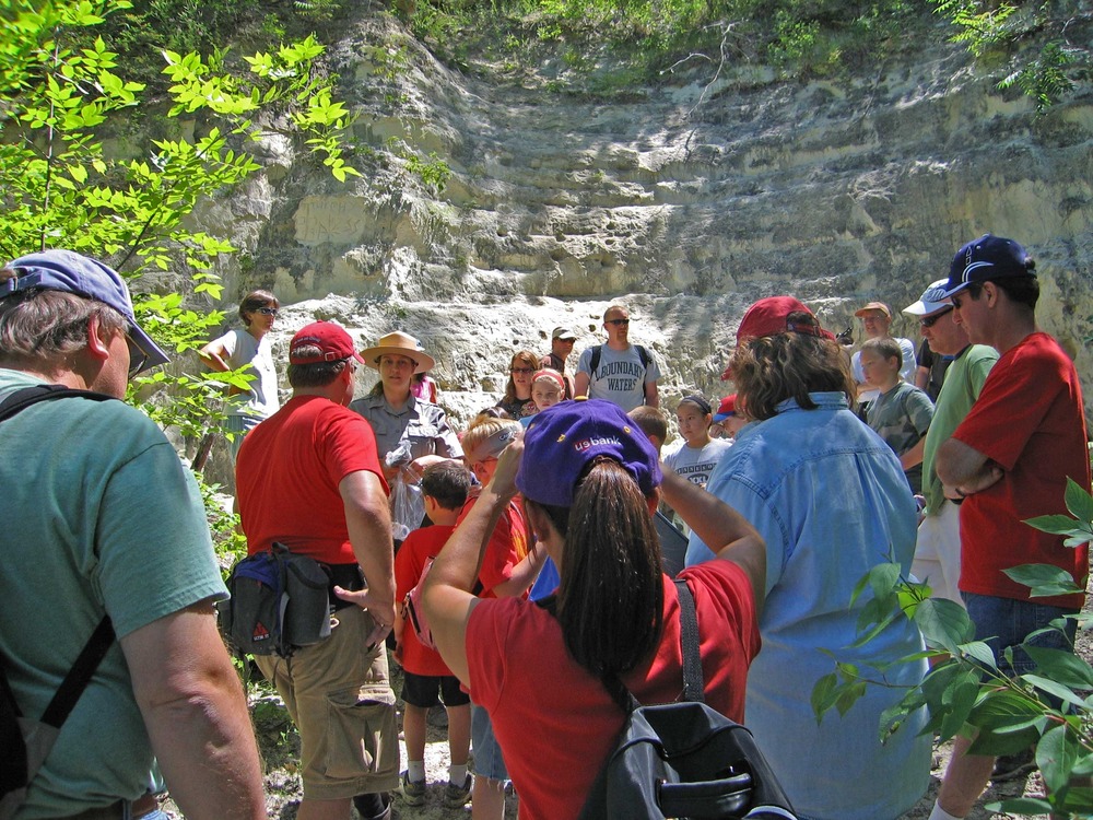 Junior Rangers gather around Ranger Rebecca to get instructions before setting off up the slope to search for Ordovician era fossils.