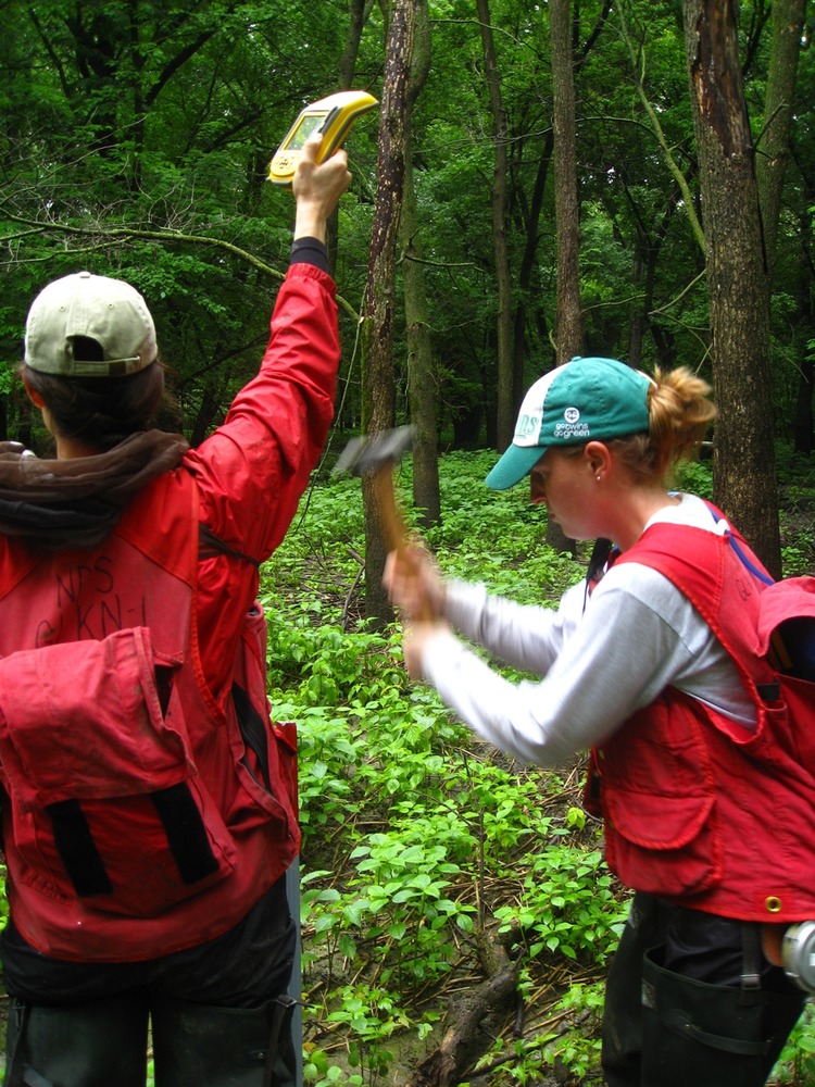 Poles to mark the corners are pounded into the ground. A GPS unit is used to record the pole's location