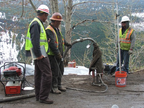 Construction crews performing compaction grouting on the Going to the Sun Road