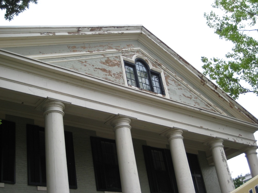 Sometimes, it really is true that things get worse before they get better. Prior to repainting, loose paint needed to be scraped off. This does leave the place looking a bit shabby now, but wait until they're done!