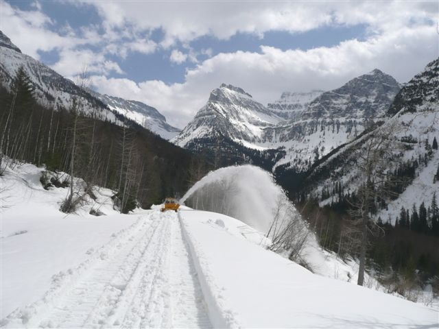 Mt. Oberlin and Mt. Cannon shine in the distance as the rotary plow blows snow off the road.