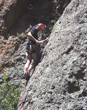 Todd Tempalski places a cam in a pocket halving the runout to the first bolt. Adrenaline Junkies 5.10c * PG Proclamation Pinnacle, High Peaks West. Cinco de Mayo 02