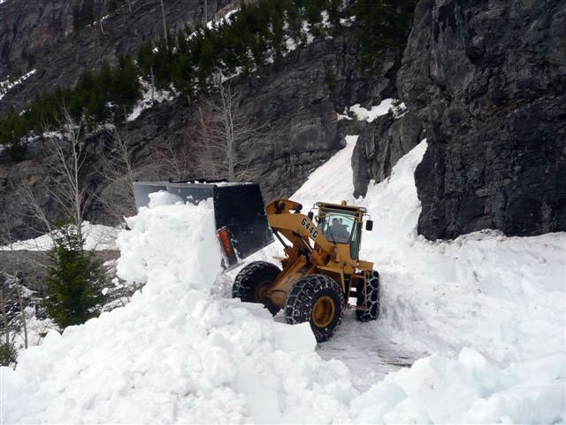 Front end loader pushing snow off the road