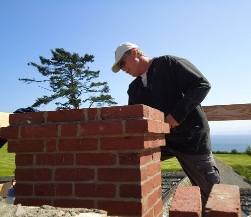 Preservation mason Miles Miller re-constructs a chimney on the Ferry House.