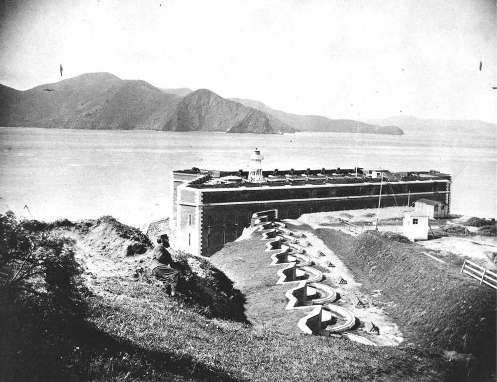 This 1869 view shows the southwest elevation of the fort and lighthouse, with the row of 10-gun batteries.
