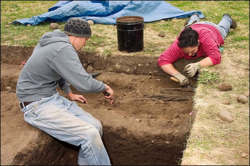 Students excavate a site as part of the site's 2005 Archaeology Field School.