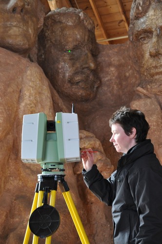 Maureen Young of Historic Scotland uses the Leica Scanstation C10 in front of the scale model the historic Sculptor's Studio.  The scanner is projecting a green dot on one of Theodore Roosevelt's eyes.