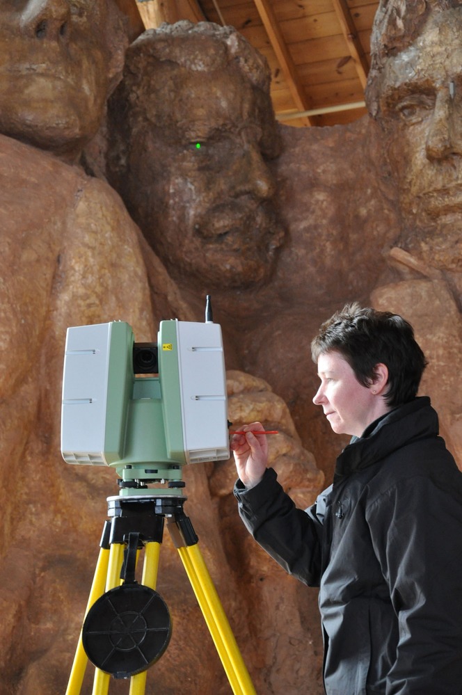 Maureen Young of Historic Scotland uses the Leica Scanstation C10 in front of the scale model the historic Sculptor's Studio.  The scanner is projecting a green dot on one of Theodore Roosevelt's eyes.