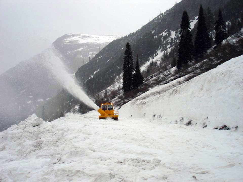 The Rotary plow blowing snow over the edge of the Going-to-the-Sun Road just below Road Camp