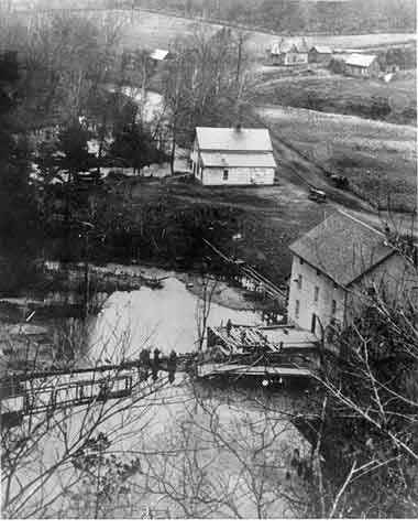 An old view of Alley Mill taken from the bluff above. The mill, dam and spillway are all visible.