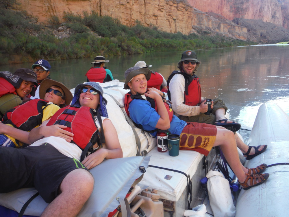 Grand Canyon Unearthed participants relaxing on a raft on the Colorado River