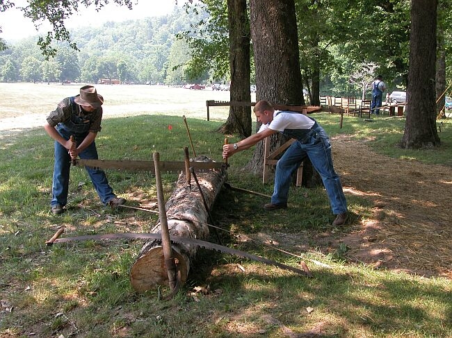 Trying out a cross-cut saw.