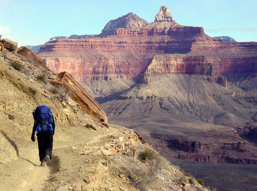 D7270 A HIKER ON THE S. KAIBAB TRAIL ABOUT HALF-WAY TO PHANTOM RANCH. ZOROASTER AND BRAHMA TEMPLES BEYOND. GRAND CANYON N. P. NPS, MICHAEL QUINN.