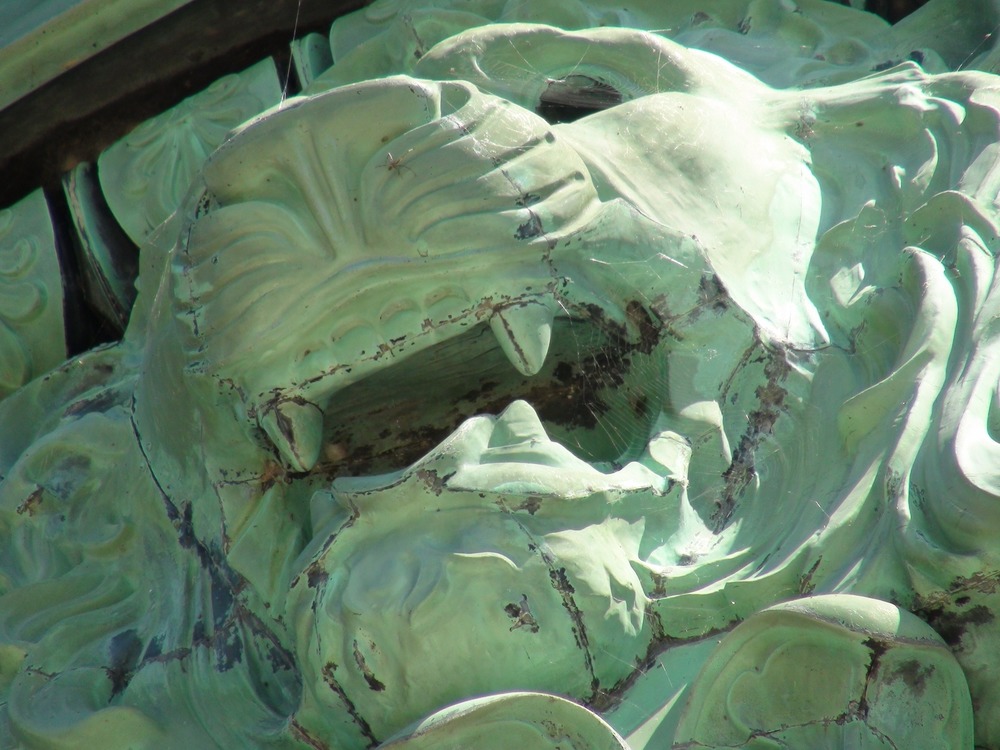 Close up of bronze lion taken from temporary decking around urn.