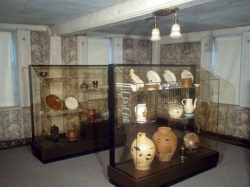 The hall of the Narbonne House is one of two original rooms of the house. Today, glass cases display some of the archaeological artifacts spanning three hundred years that were found in the backyard.