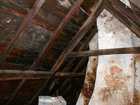 The attic still shows the massive central chimney typical of 17th century houses, and the original rafters still support the high peaked roof.
