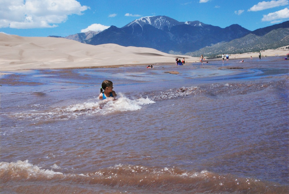 A girl enjoys the wave action of Medano Creek at Great Sand Dunes National Park in May 2010.
