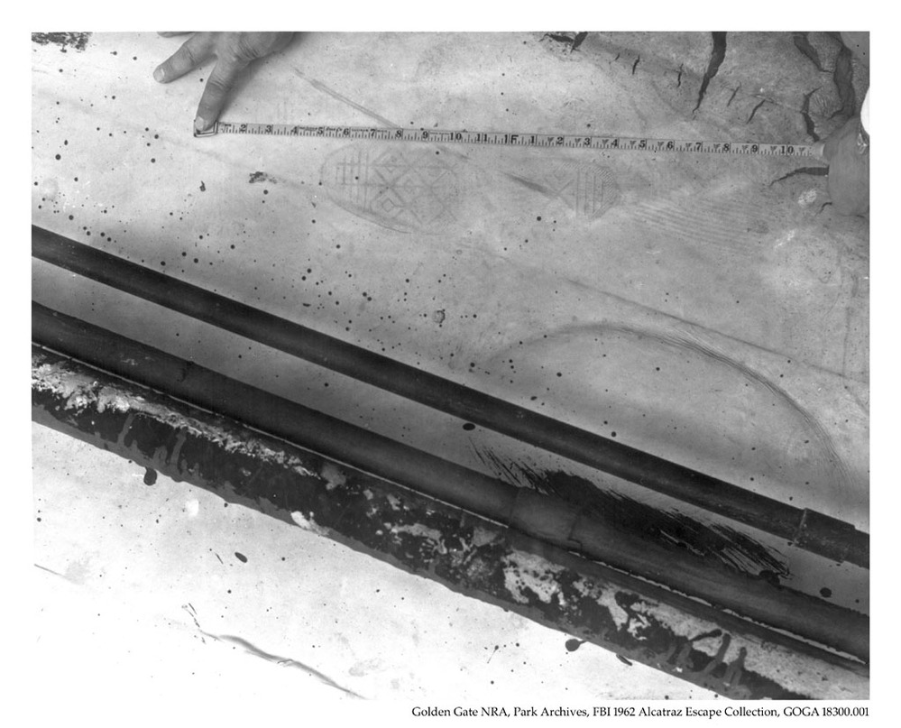 Image from the FBI 1962 Escape file of a footprint found on the roof after the escape. The caption states: "This is a photo of an imprint of what appears to be the left foot. This print is headed in a Northwesterly direction... 6/12/1962."