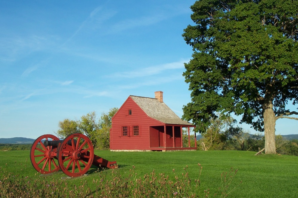 Late afternoon summer sun brings out the deep red of this one-room farmhouse that served as a mid-level headquarters building for the American army during the Battles of Saratoga.