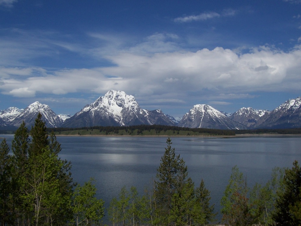 Mount Moran with snow and Jackson Lake with clouds.