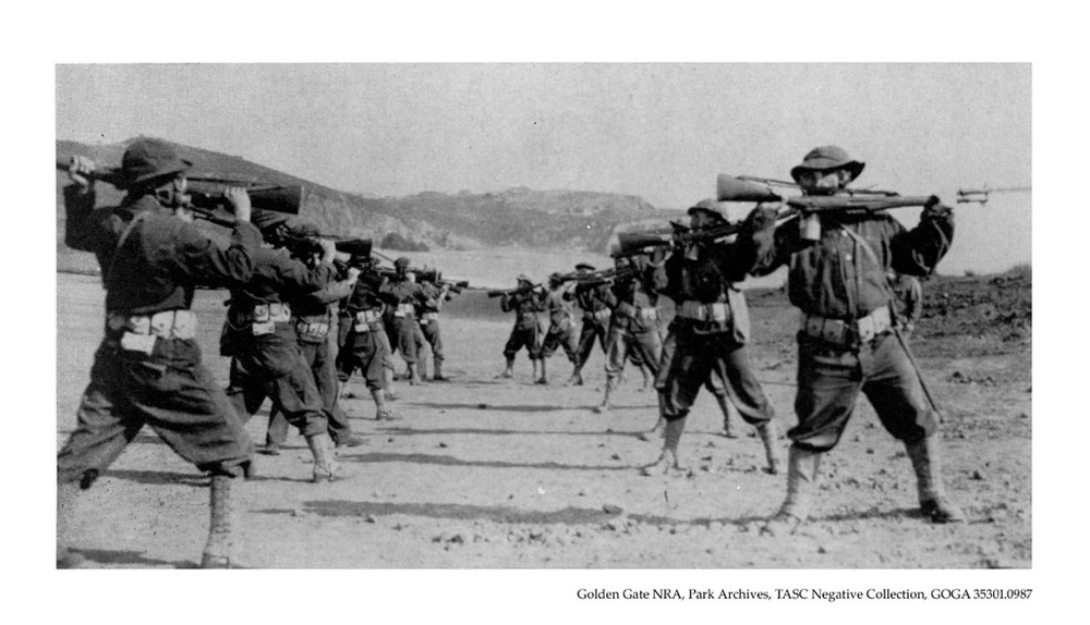 CAC soldiers practice bayonet and rifle drills at Fort Cronkhite. Note the use of gas masks. Picture taken: 1941.