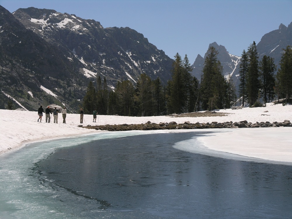hikers, Lake Solitude, partly frozen, snow on ground
