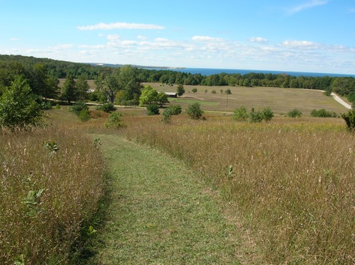 Thoreson farm from the Bay View Trail in September with leaves on the trees.