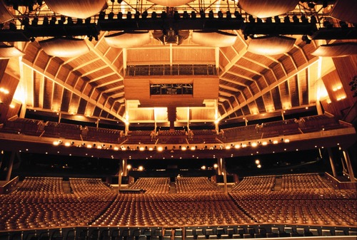 A large auditorium with many seats and lights.