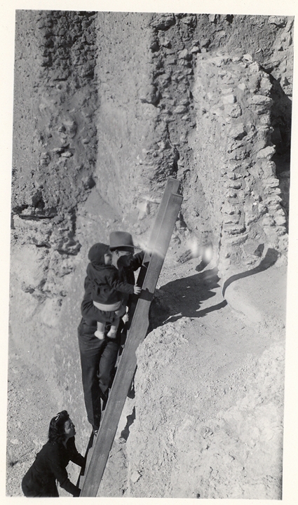 An unknown family climbing ladders into Montezuma Castle. Tours of the castle interior were stopped in 1951 due to severe damage to the structure and questions about its safety.