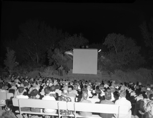 Ranger speaking to visitors at campfire program on Campfire Day, September 19, 1956 at South Campground amphitheater.