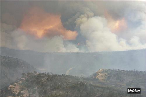 Intense burning with heavy gray and black smoke and flames during the Bircher fire, Mesa Verde National Park, July 2000